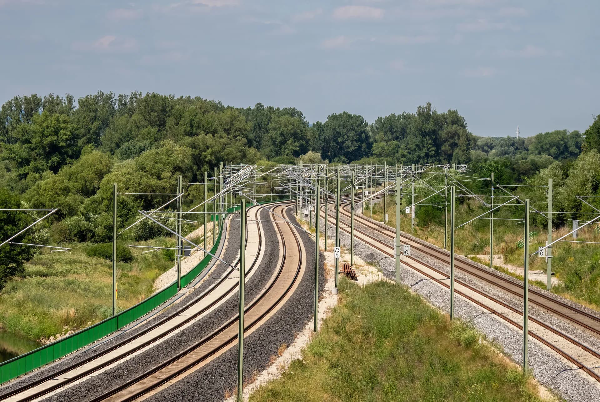 Zweigleisige Bahnstrecke bei Tageslicht — Oberbau und Oberleitung im ruhigen Streckenverlauf
